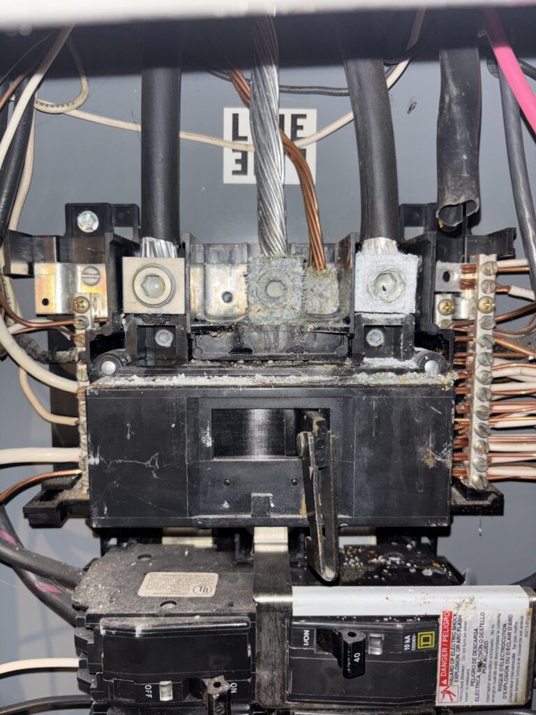 Corrosion around electrical panel service lugs and neutral connection in a Maine home
