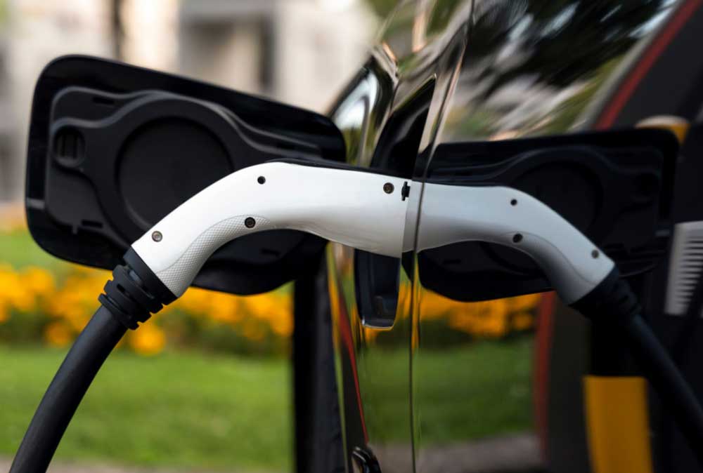 Someone charging an electric vehicle