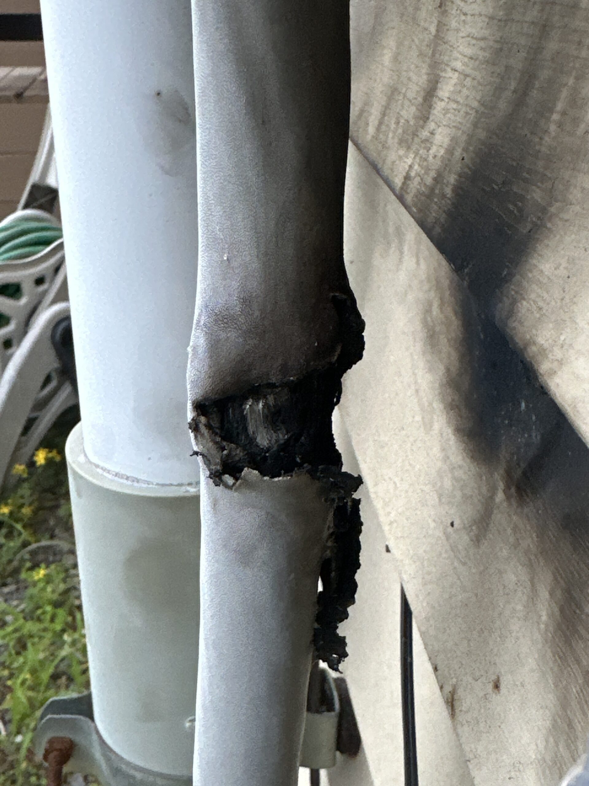 Heat-damaged electrical service conduit discovered at a Maine home