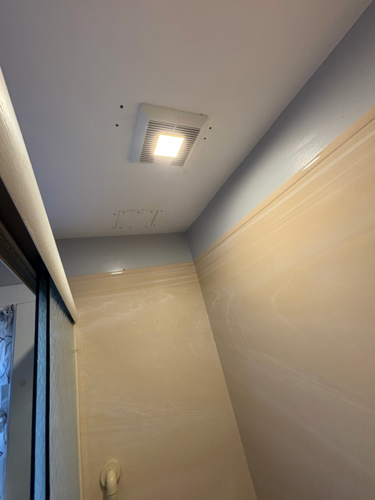 New bathroom exhaust fan installed with ceiling venting in residential bathroom Electrician Lisbon ME